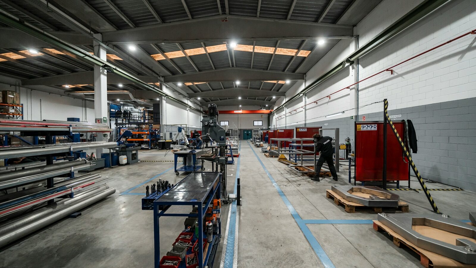 Wide aisle of a factory floor with machinery and materials