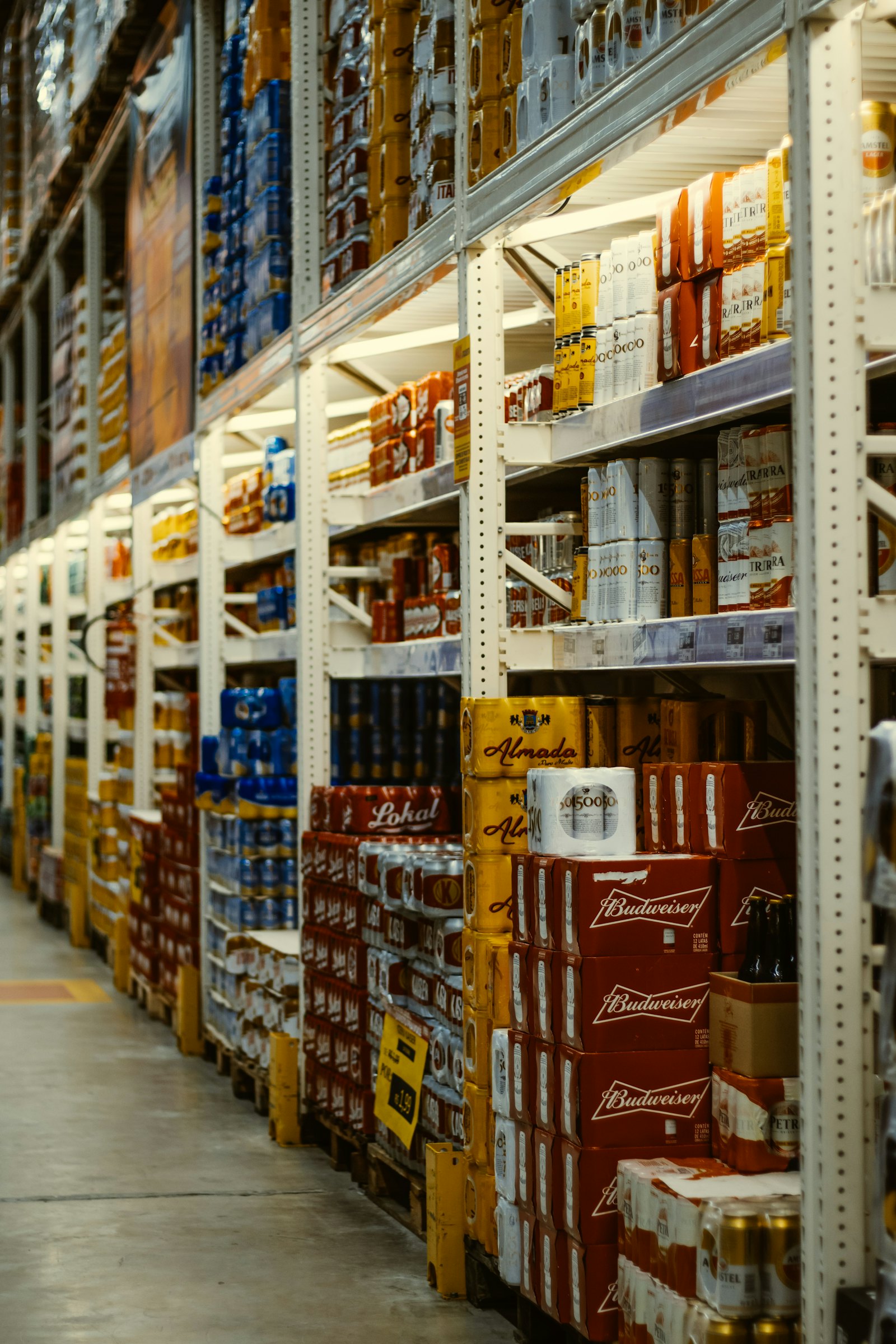 Red and white canned drinks stacked on a shelf