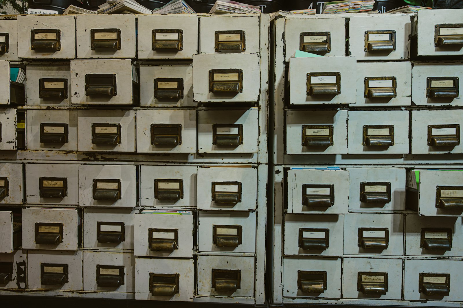 Rows of old labelled filing cabinet drawers in an archive