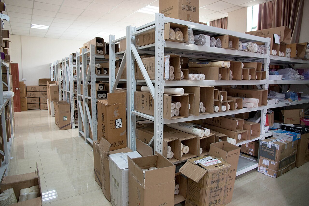 Industrial shelving holding cartons and rolls of stored material