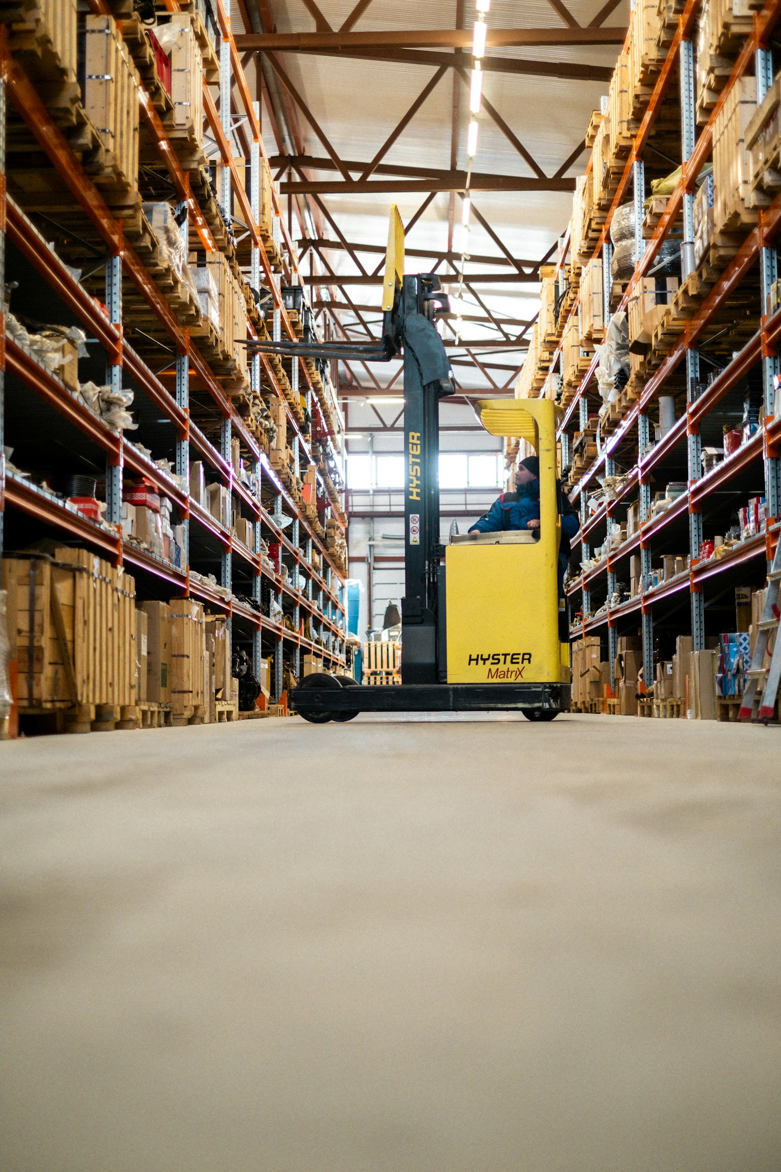 Warehouse interior with tall shelving stocked with boxes and supplies