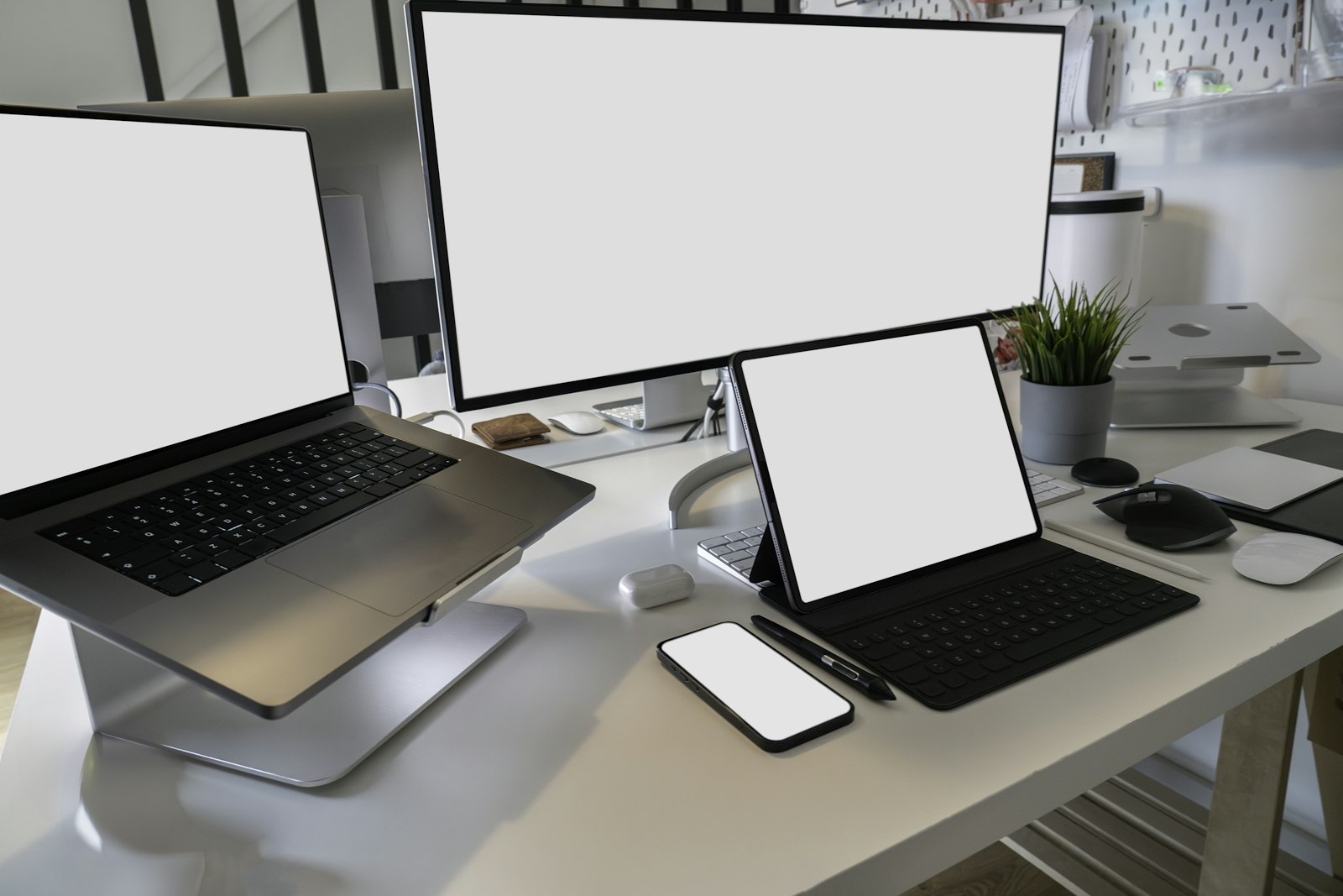 Desk with two laptops and a phone